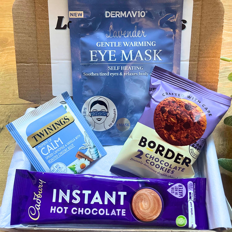 a gift box containing a lavender face mask, chocolate biscuits, calm tea bag, hot chocolate sachet and marshmallows.